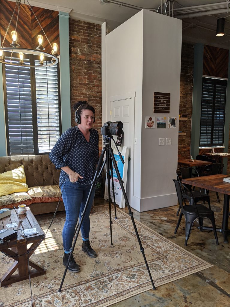 Camera and boom microphone set up for an interview inside a historic downtown storefront