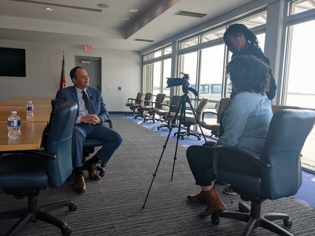 Video interview setup with a community leader being filmed on location
